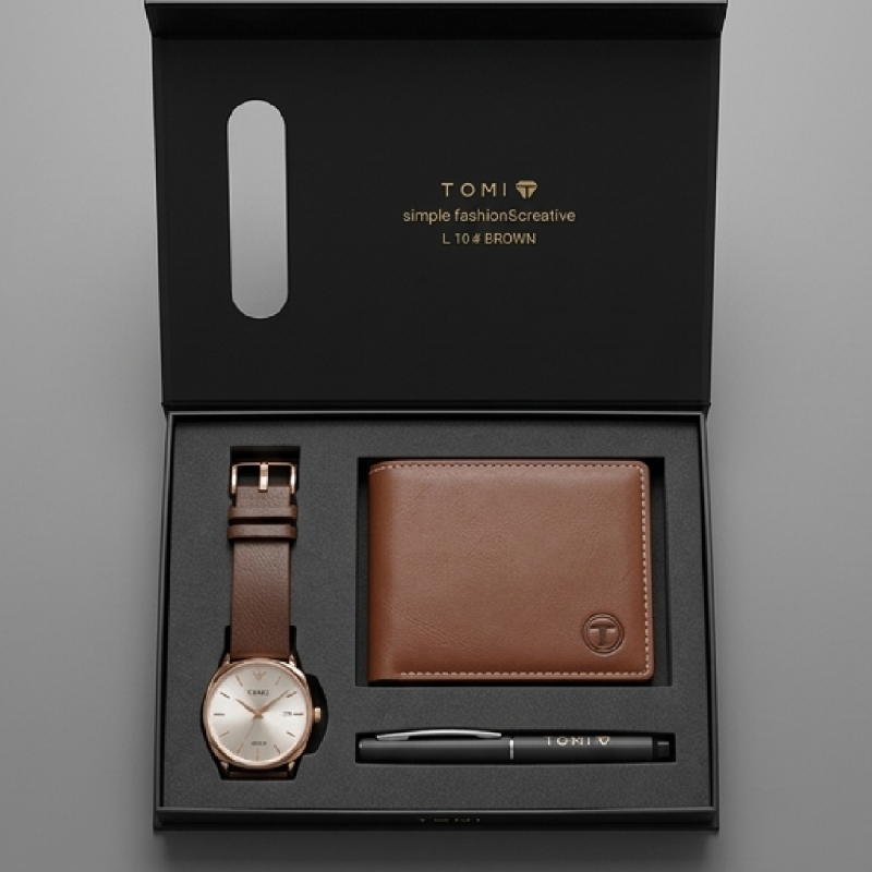 Tomi men's gift set in a black presentation box, featuring a brown leather bifold wallet, a brown leather strap watch with a rose gold-toned case, and a black pen.
